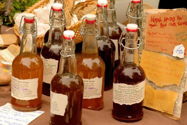 Bottles of apple cider vinegar on market stall